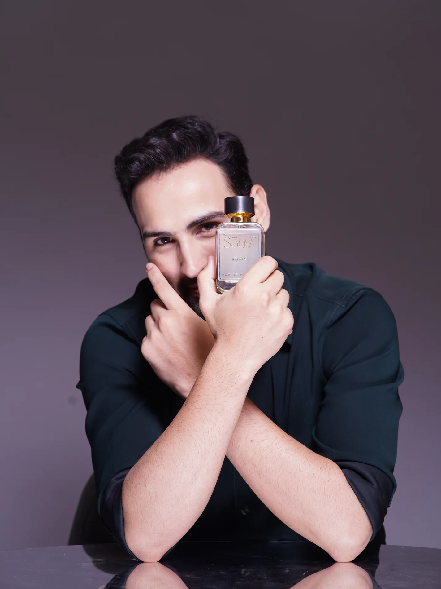 Model holding S369 Crimson Musk perfume